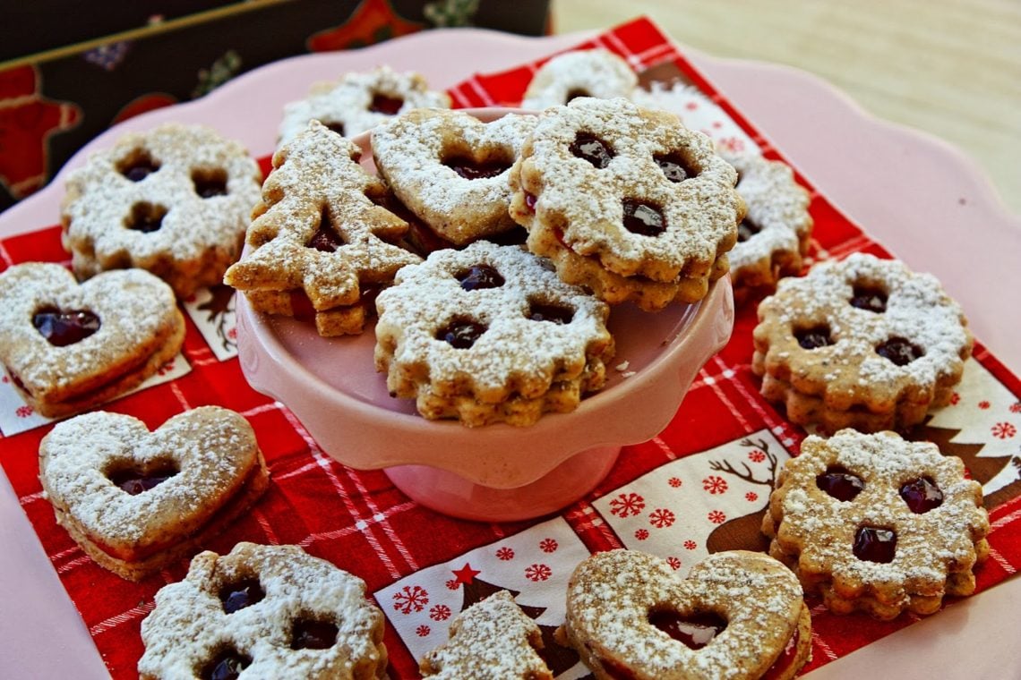 traditional Austrian Linzer cookies arranged on a tiered cake stand