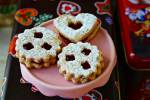 three Austrian Linzer cookies on a cookie stand