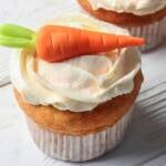 carrot banana muffins with quark frosting topped with a marzipan carrot