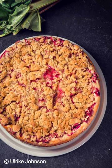 overhead shot of a rhubarb raspberry crumble cake with streusel topping
