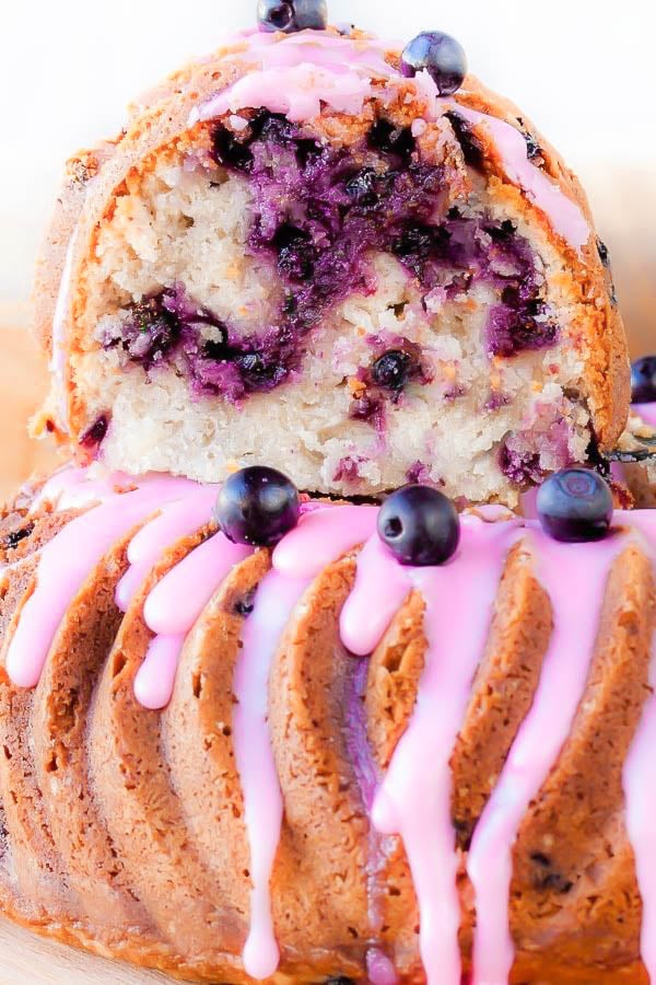 a piece of nanny's blueberry sour cream bundt cake stacked on the the whole bundt cake