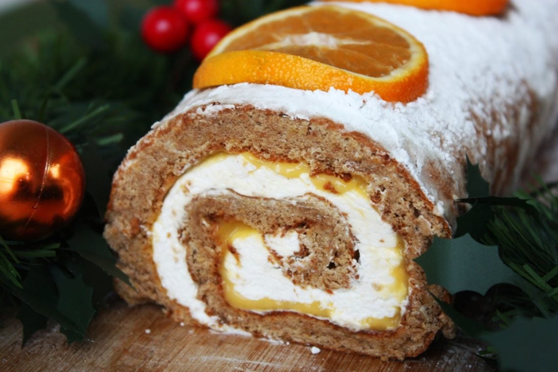 Gingerbread Cake Roll with Tangerine Curd and Vanilla Cream on a wooden board