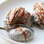 a scoop of black sesame ice cream with a scoop digging in