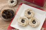 German poppy seed marzipan cookies with jam on a white plate