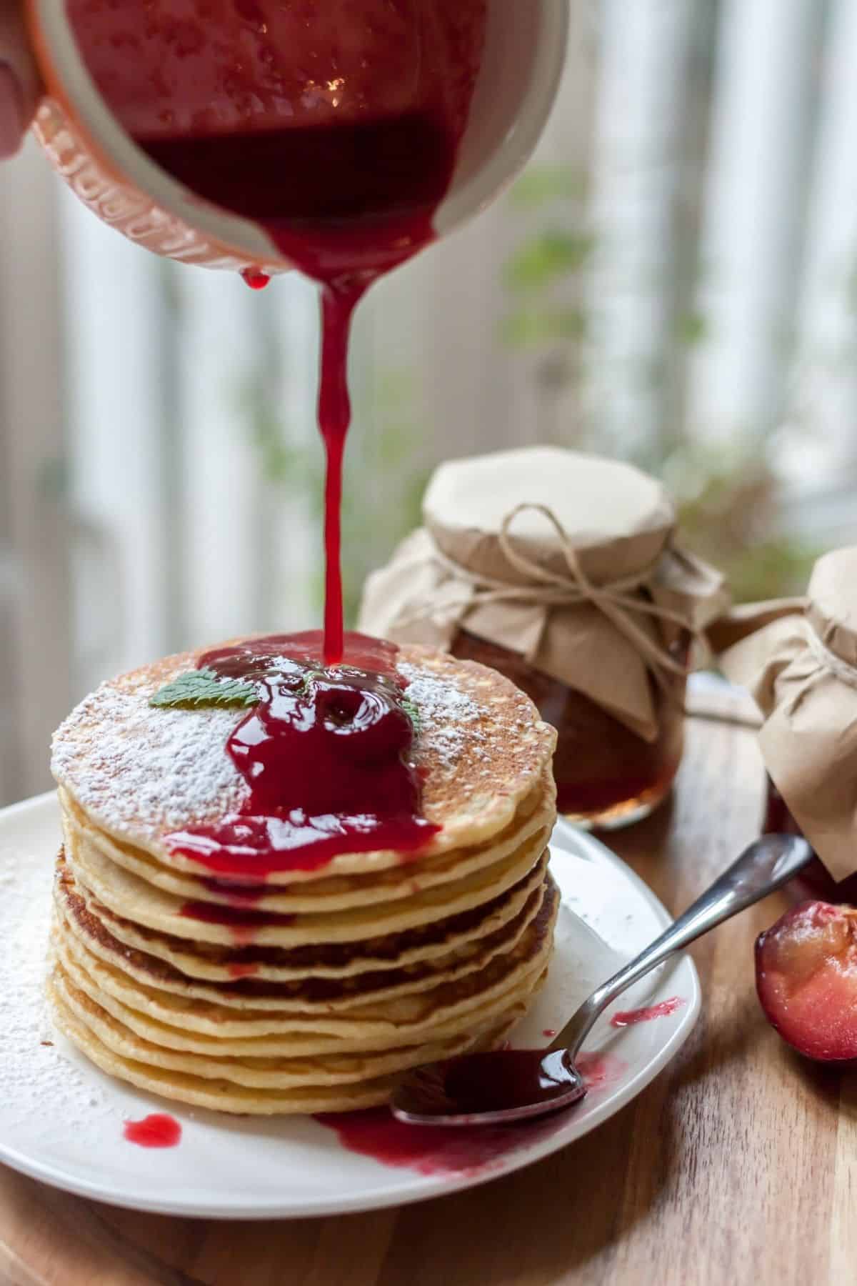 a stack of pancakes topped with mulled wine jam 