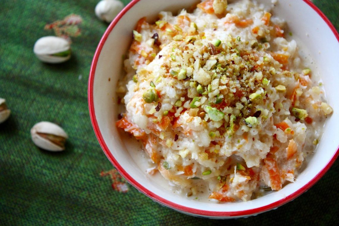 Indian Rice Pudding Kheer in a white bowl topped with chopped pistachios