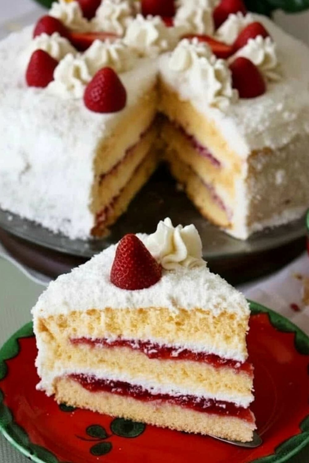 a slice of german strawberry coconut cake on a red cake plate 