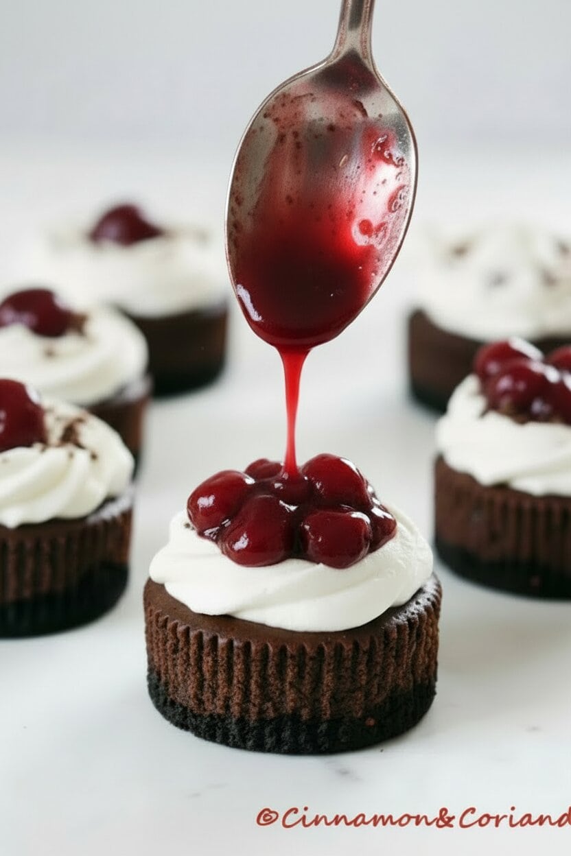 cherry filling being drizzled over a black forest mini cheesecake 