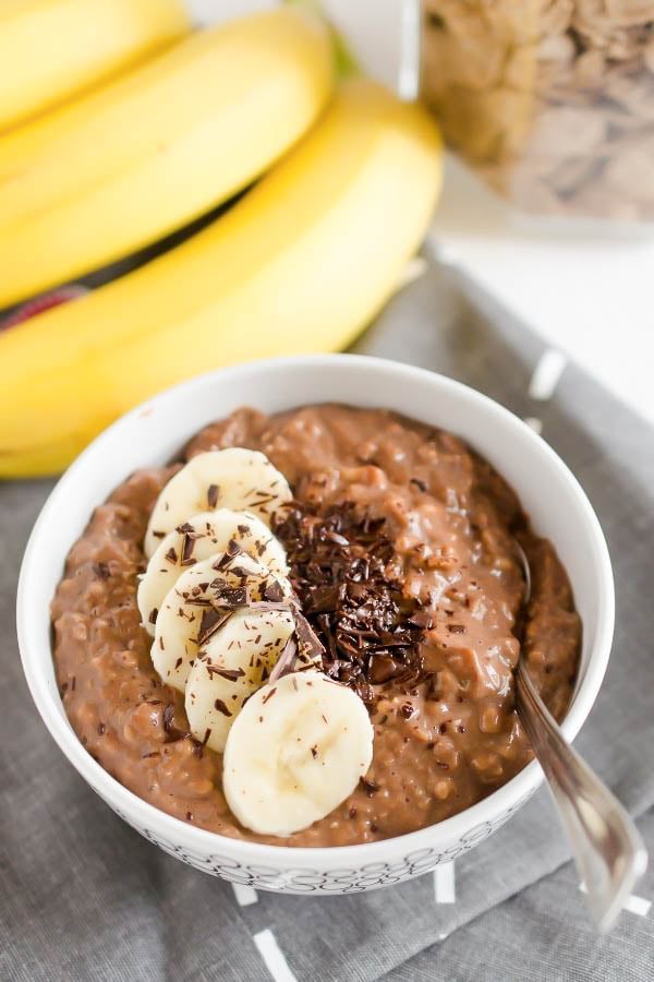 overhead shot of a bowl with creamy vegan brownie batter oatmeal topped with banana slices