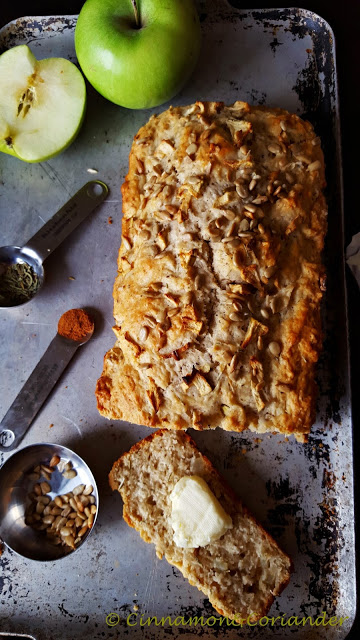 A slice of oven-warm apple bread with a chunk of salted butter on top