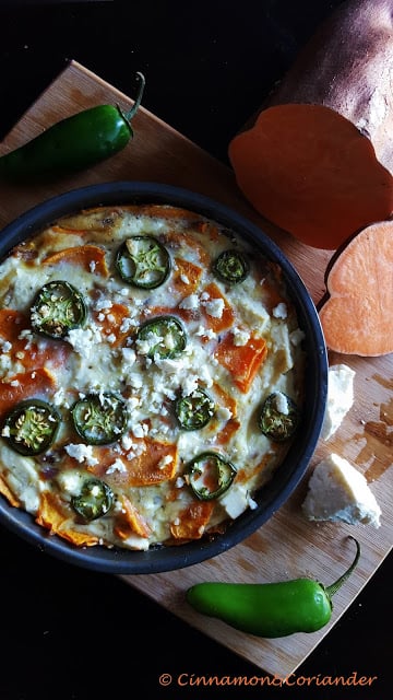 sweet potato frittata with feta and japaleno chilies in a black skillet