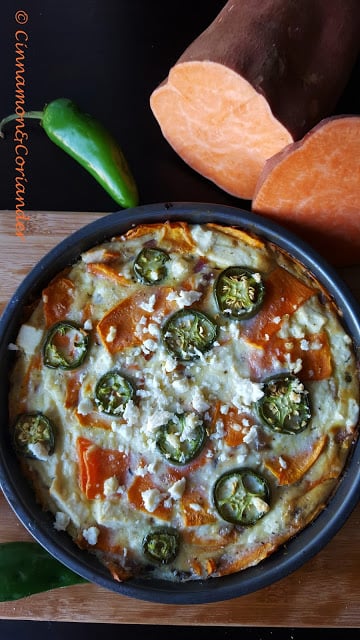 overhead shot of a sweet potato frittata with feta cheese served in a black skillet