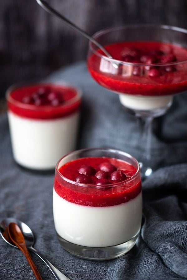 goat cheese panna cotta with cranberry port topping decorated with stewed cranberries