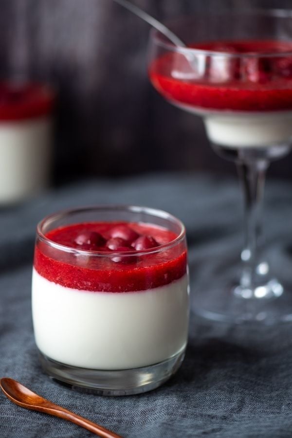 side view of a glass of cranberry goat cheese panna cotta 