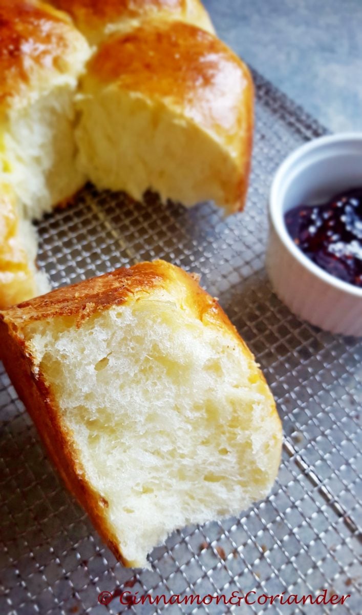 a freshly baked brioche bun on a cake rack