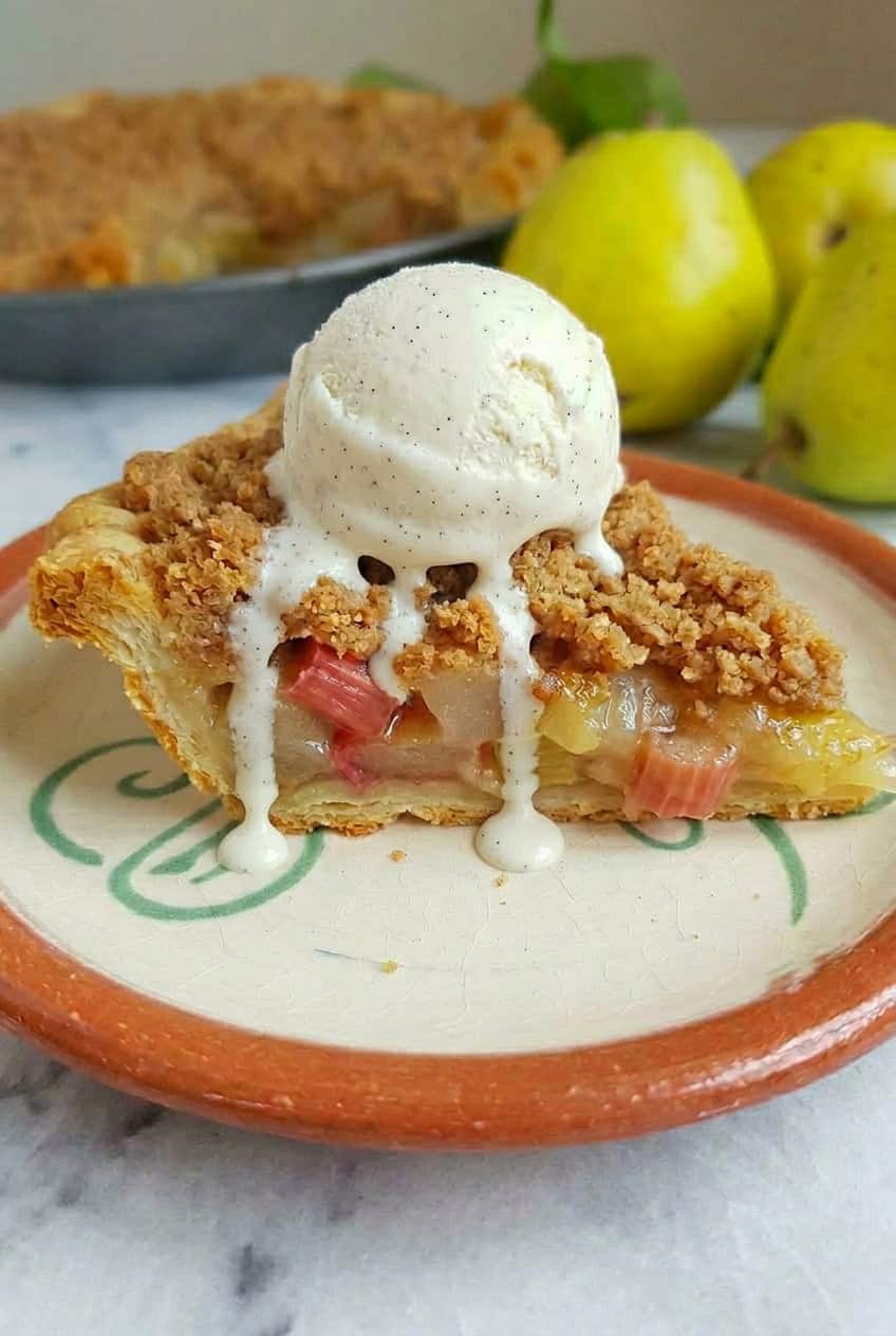 a slice of Pear and Rhubarb Crumble Pie served with a scoop of ice cream on top
