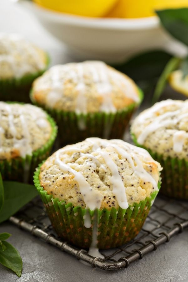 lemon poppyseed muffins glazed with lemon icing on a cooling rack