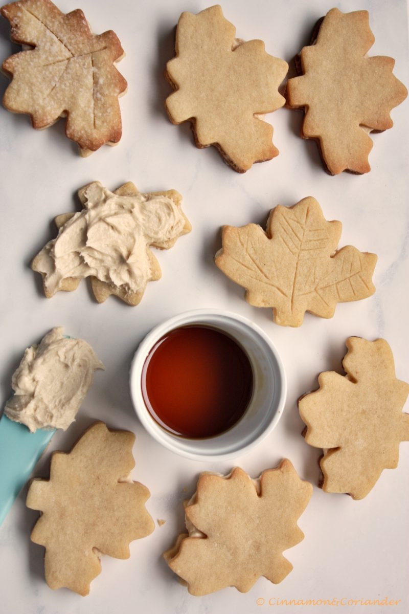 Homemade Maple Cream Cookies with a small dish of maple syrup on the side