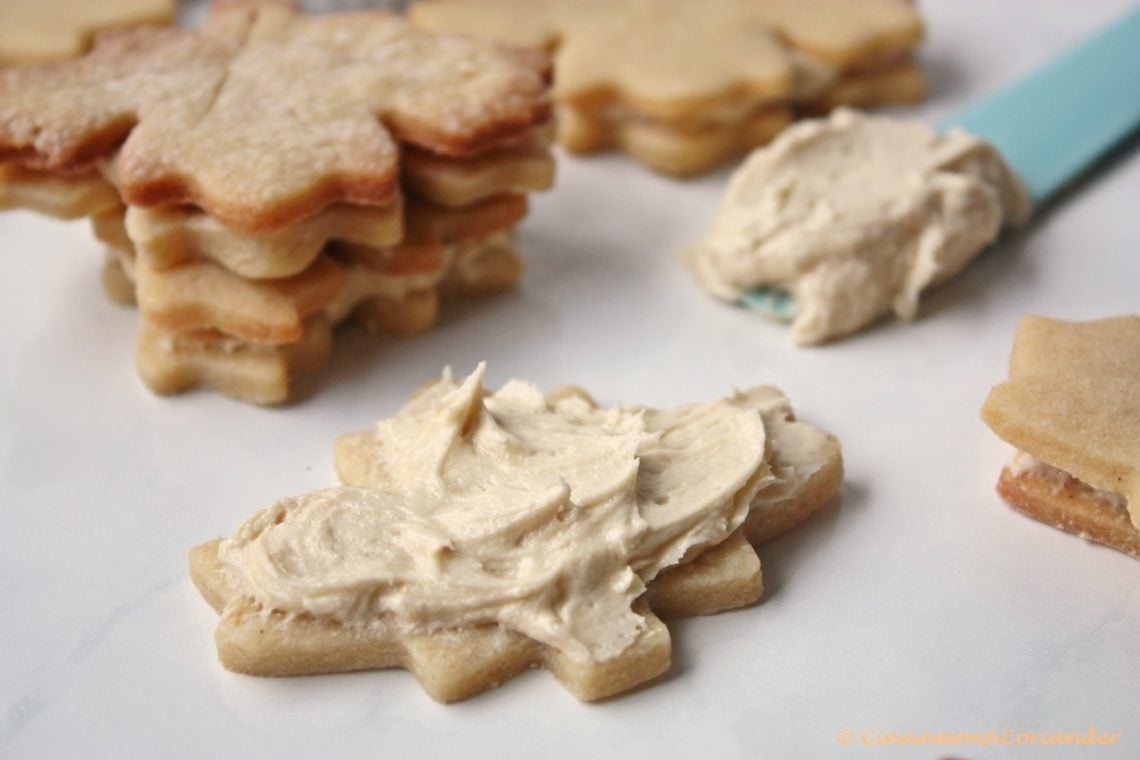 maple cream cookies being filled with maple buttercream 