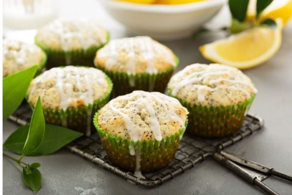 lemon poppyseed muffins drizzled with lemon icing on a metal rack
