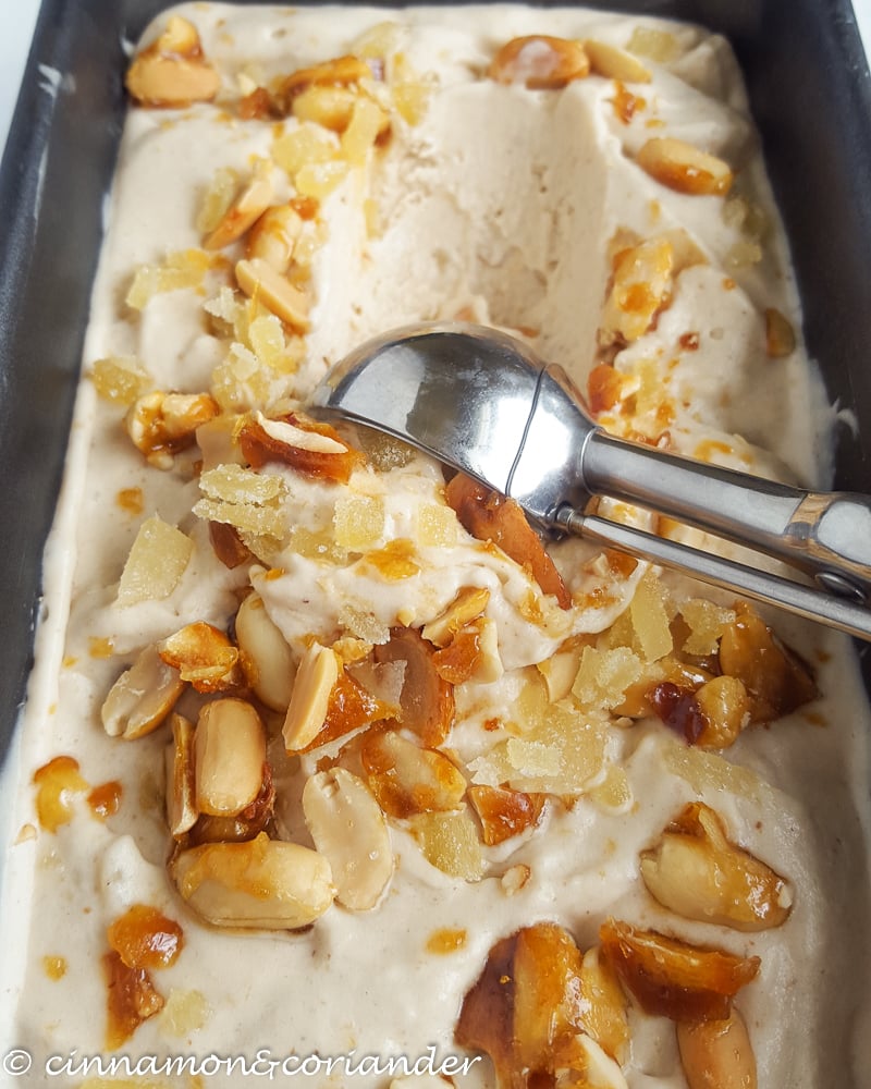 Thai Peanut Ice Cream with Caramelized Peanuts and Candied Ginger being scooped with an ice cream scoop
