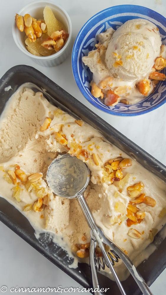 Jeni Britton Bauer Thai Peanut Ice Cream with Caramelized Peanuts and Candied Ginger being scooped into a small blue bowl