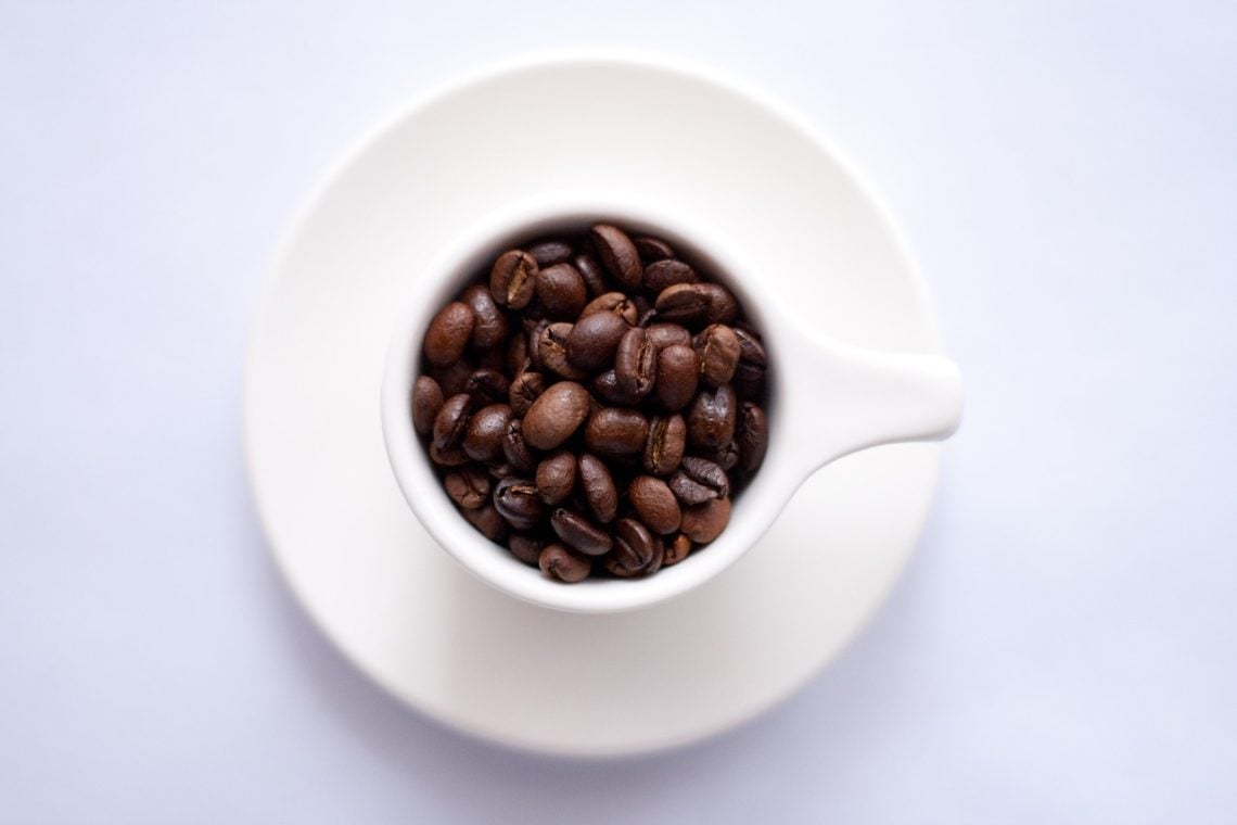 espresso beans in a white espresso cup