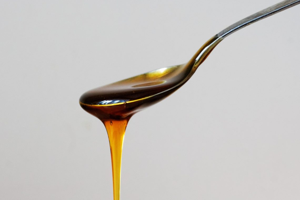 maple syrup running off a teaspoon
