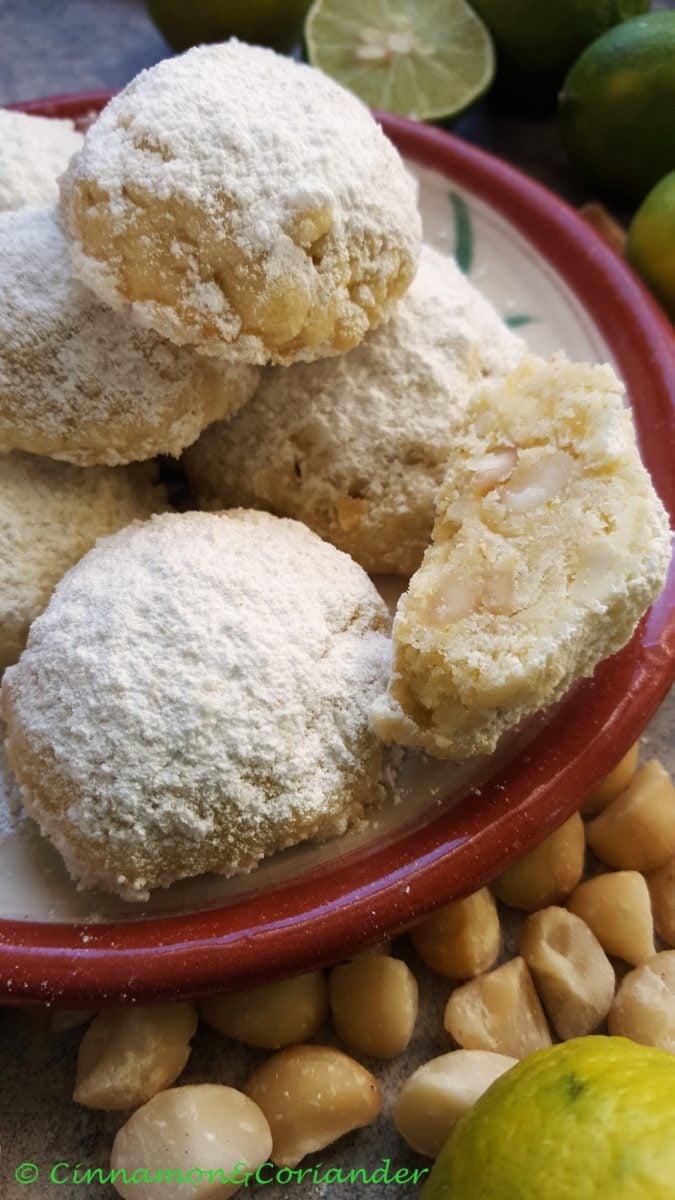 close up of a plate of buttery Mexican Wedding Cookies with Lime and Macadamia Nuts