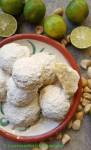 Polvorones Mexican Wedding Cookies with Lime and Macadamia Nuts on plate with fresh limes in the background