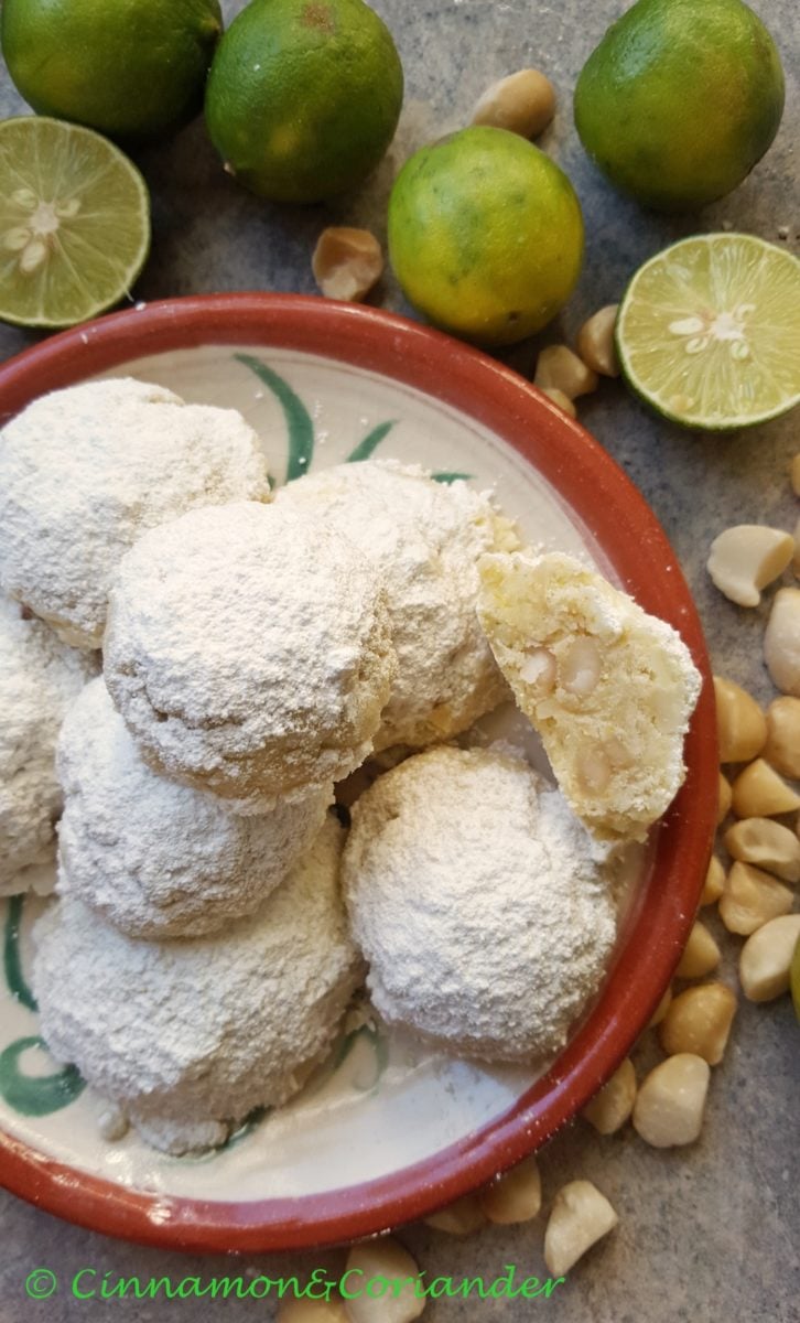 overhead shot of a plate of sugar-dusted Polvorones Mexican Wedding Cookies with Lime and Macadamia Nuts 