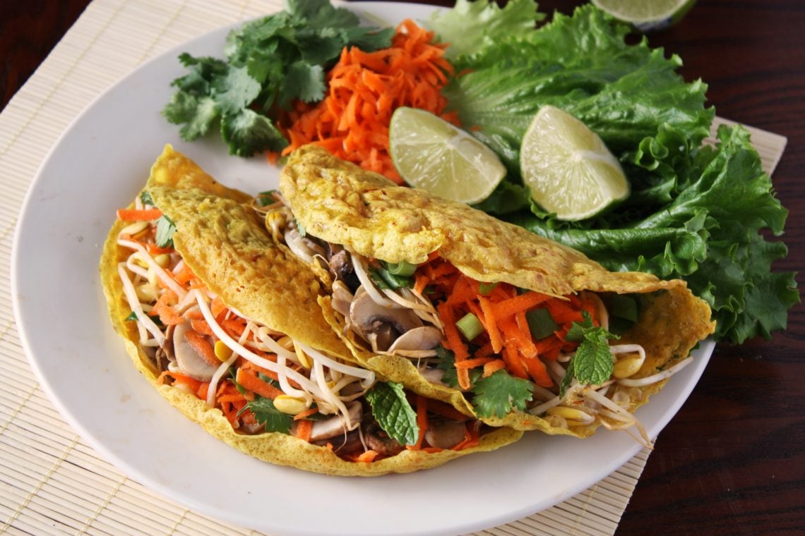 Crispy Vegan Vietnamese Rice Flour Crepes with healthy vegetable filling on a white plate