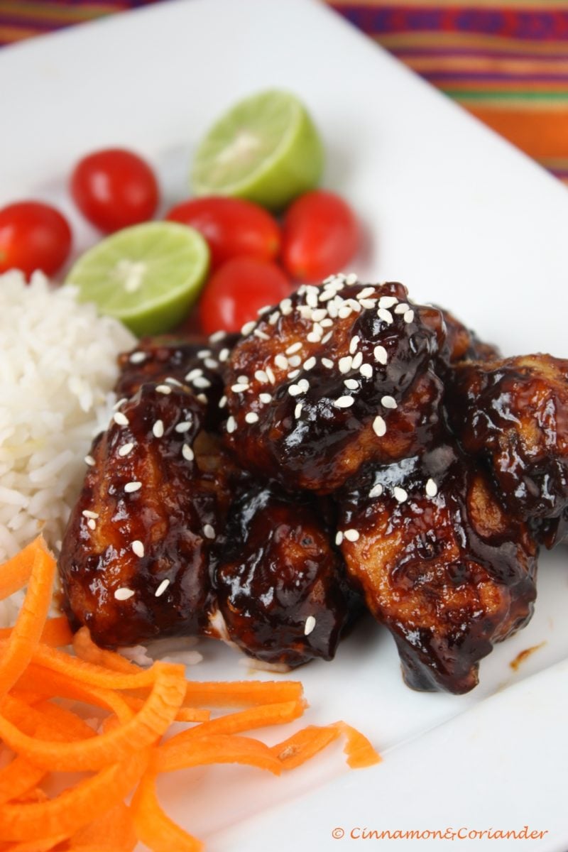 side view of Vegan General Tso Cauliflower in a sweet and sour sauce, with a side of rice and Asian chopped salad