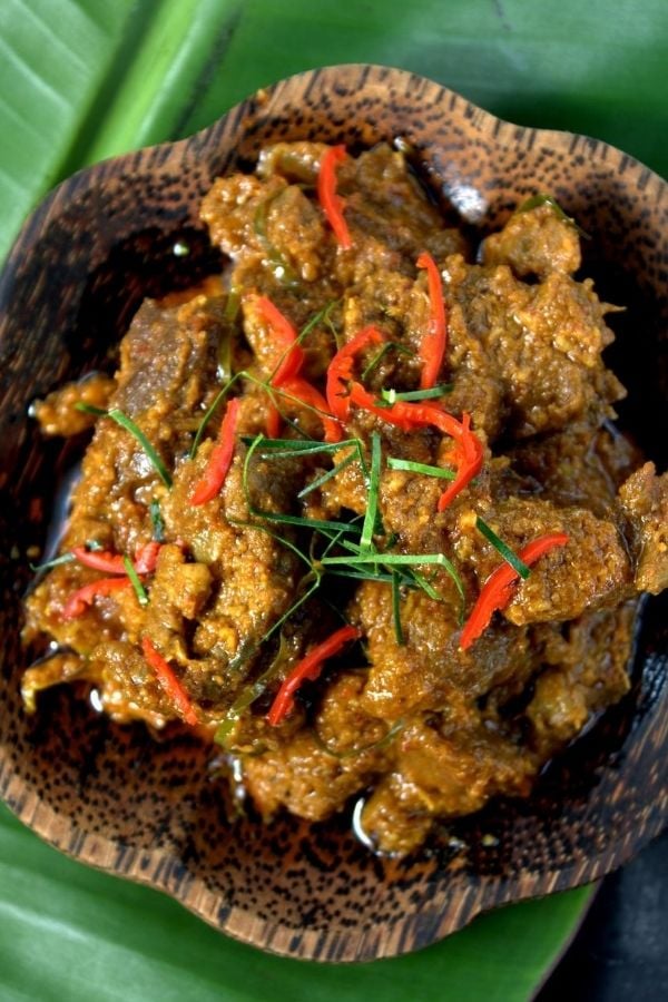 beef rendang topped with chili and kaffir lime leaves 