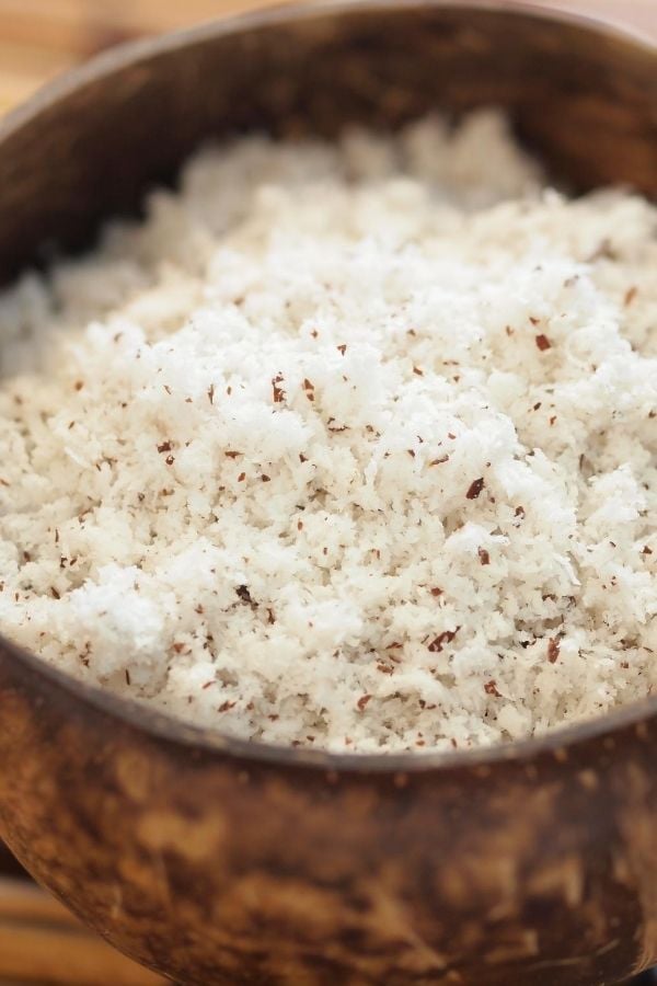 freshly grated coconut for making kerisik in a bowl