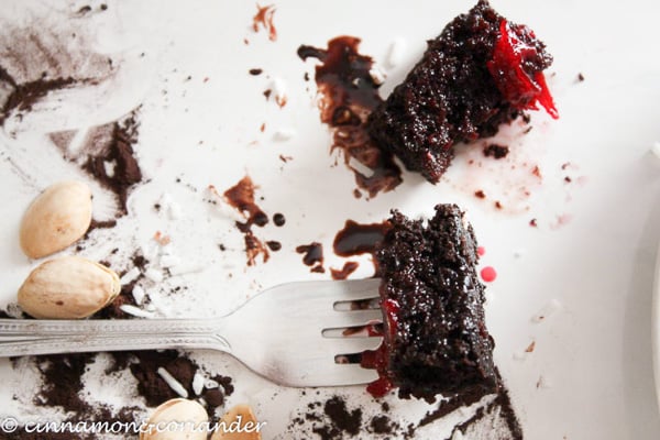 a half eaten chocolate lamington with sour cherry filling