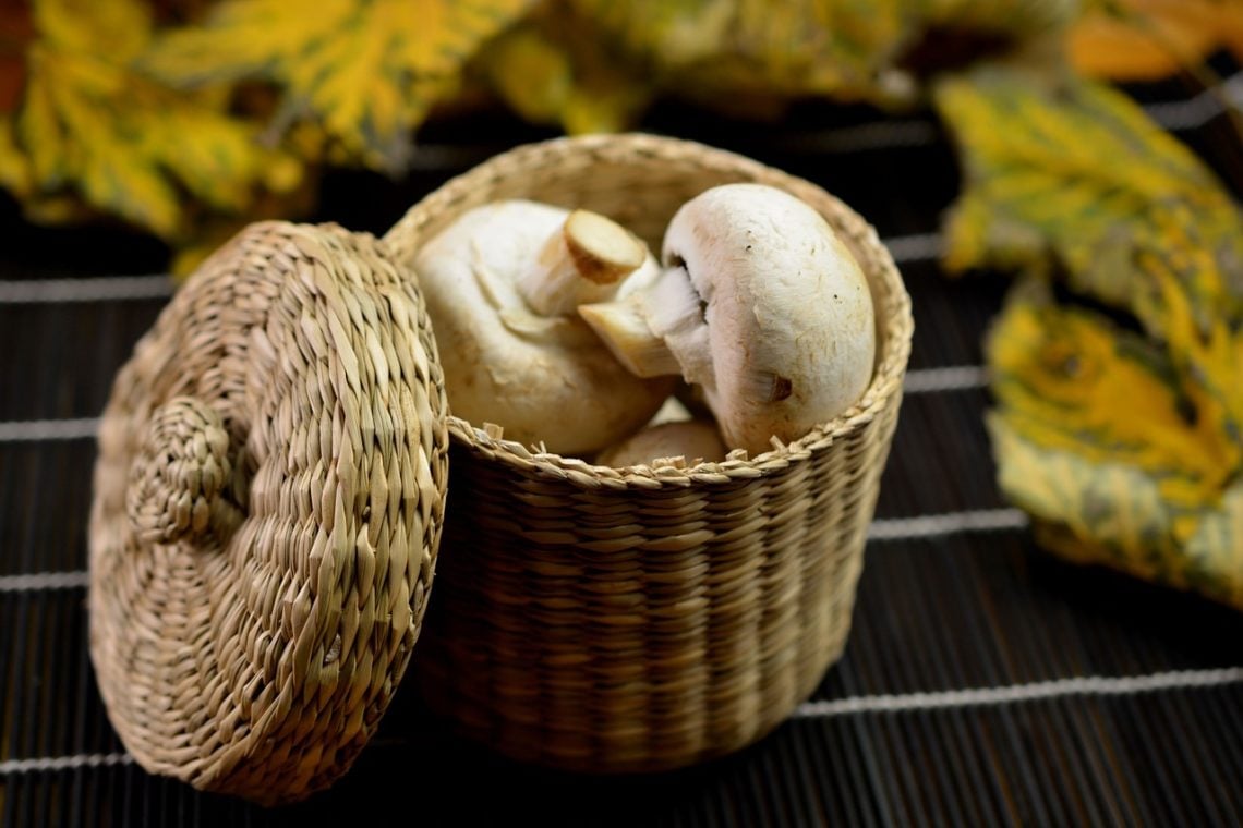 button mushrooms in a little wicker basket put aside for a mushroom tikka masala recipe