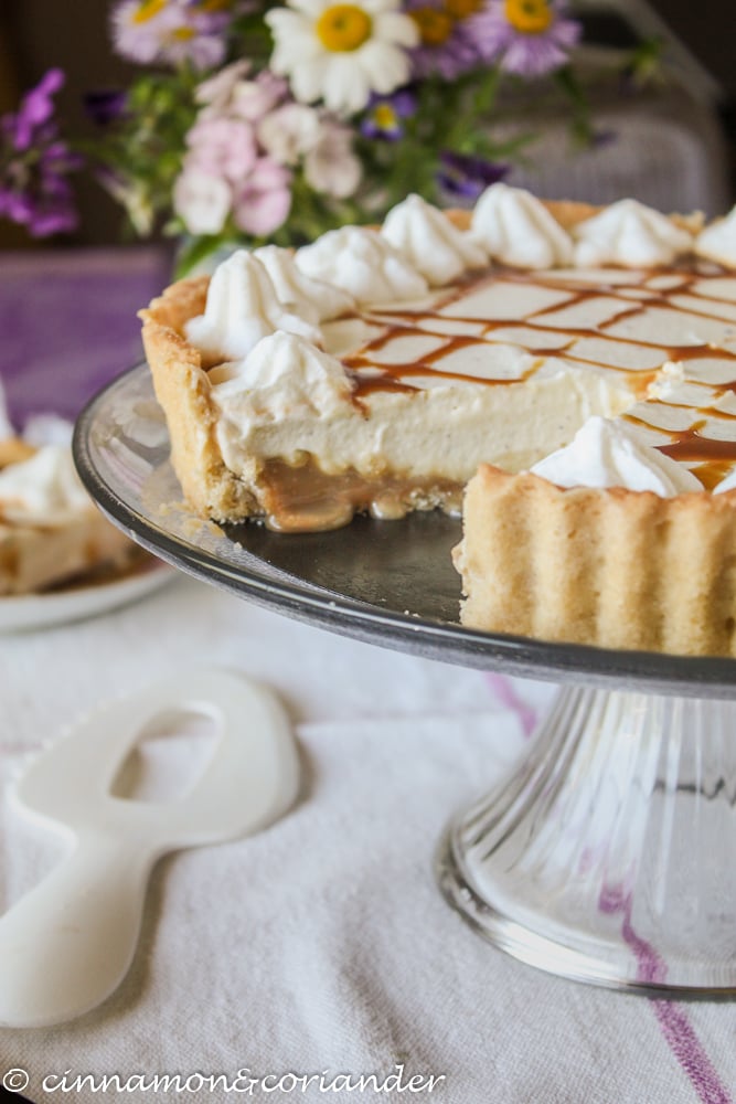 No Bake Salted Maple Caramel Cheesecake Tart on a glass cakestand 
