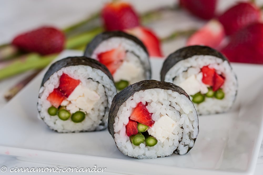vegetarian sushi with strawberries asparagus and feta cheese on a plate