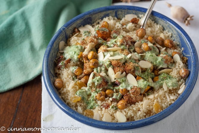 Orange Almond Couscous with oven roasted chickpeas cauliflower and mint tahini sauce - overhead shot