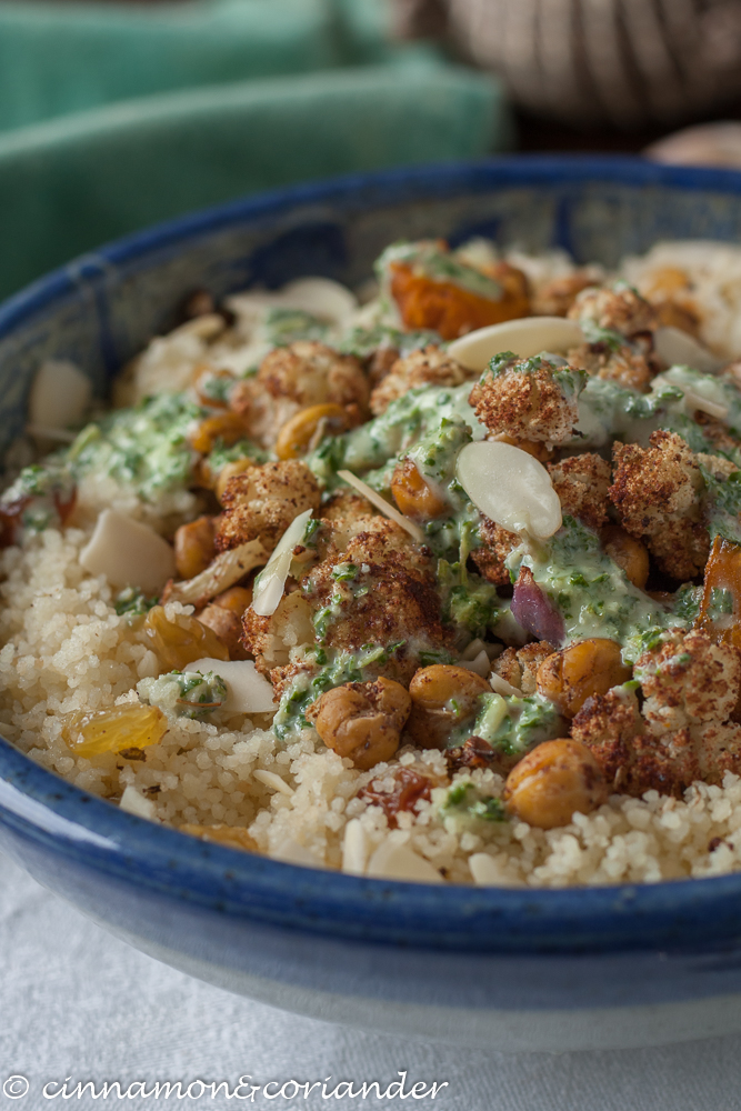 Vegan Couscous Bowl with roasted chickpeas, cauliflower and squash served with tahini mint sauce