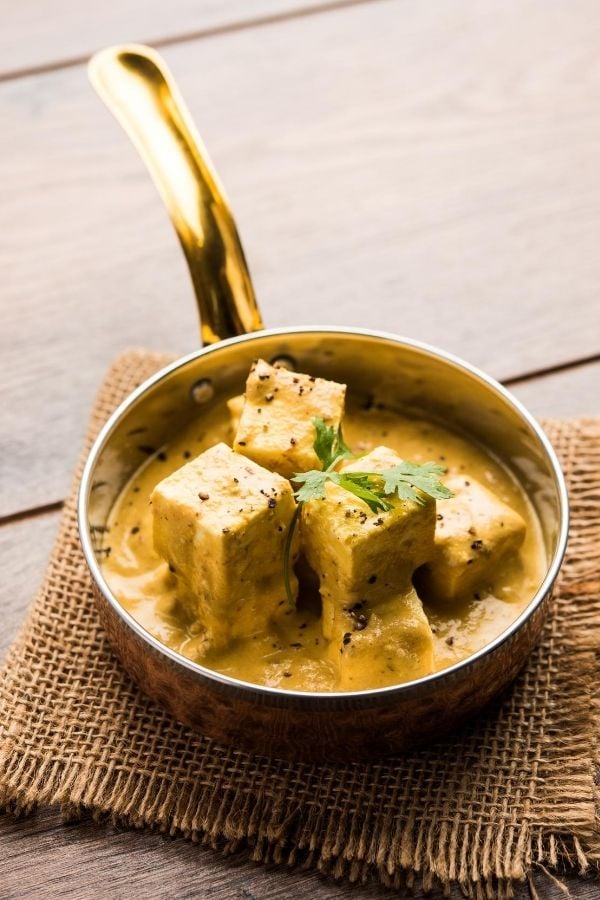 side view of Indian achari paneer in yogurt gravy