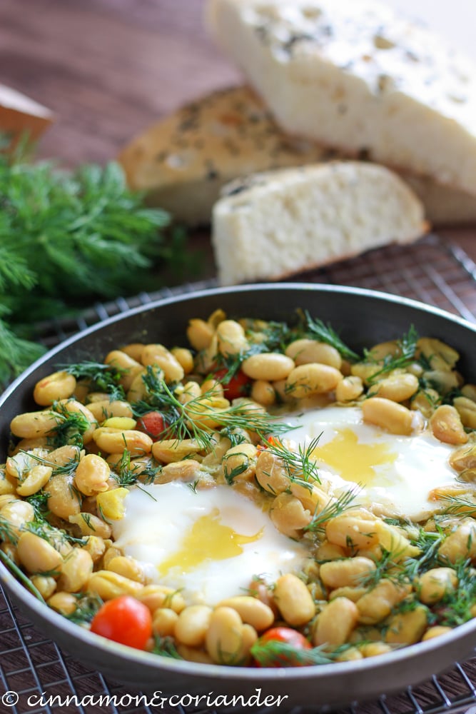 Baghali Ghatogh - Lima Beans with Dill and Eggs served in a black skillet with pita bread