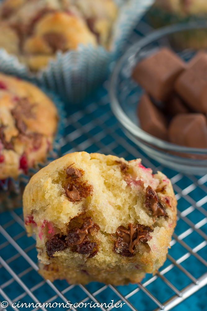 easy vanilla raspberry muffins with melted chocolate chips on a cooling rack