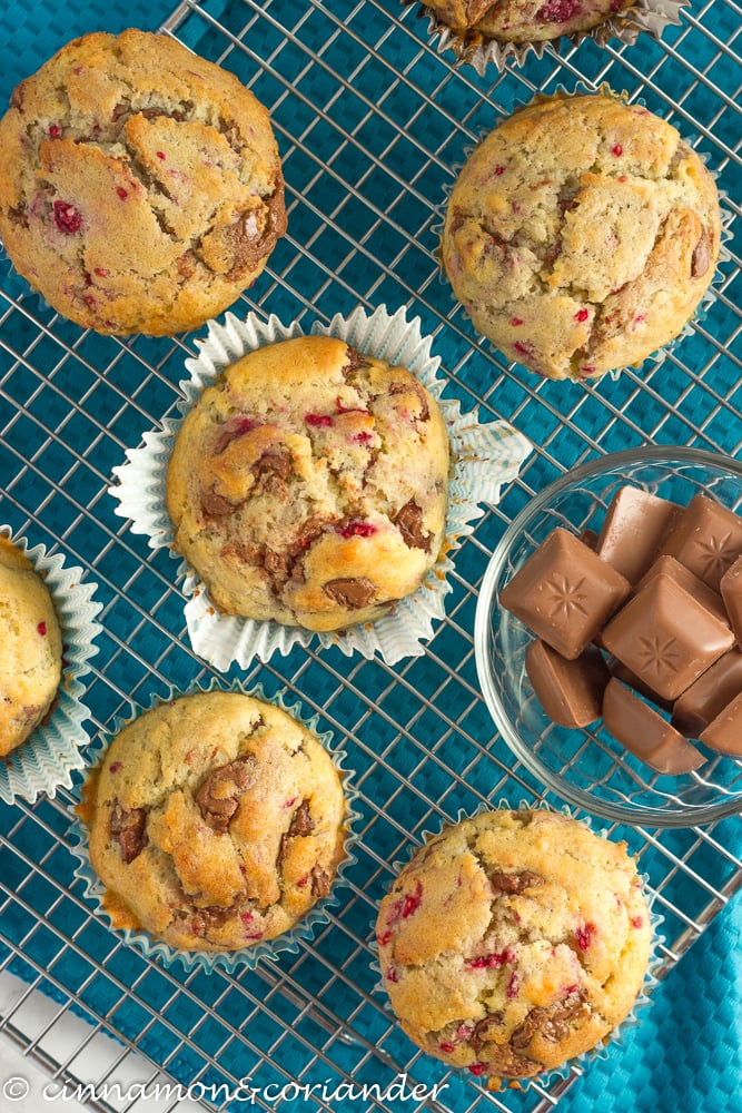 easy raspberry muffins with hazelnut chocolate chunks on a cooling rack