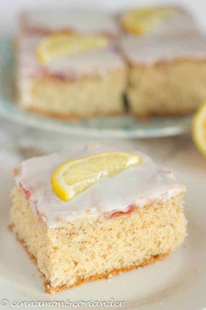 gluten free hazelnut eggnog sheet cake with lemon icing - a square of cake on a plate
