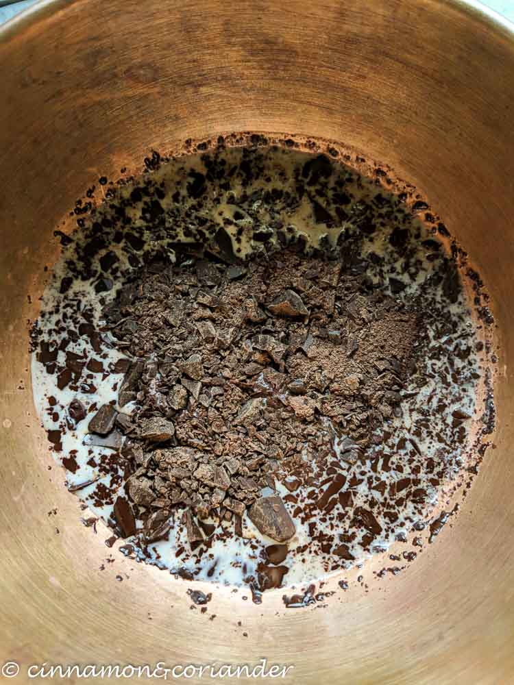 chopped dark chocolate melting in coconut milk over hot water bath