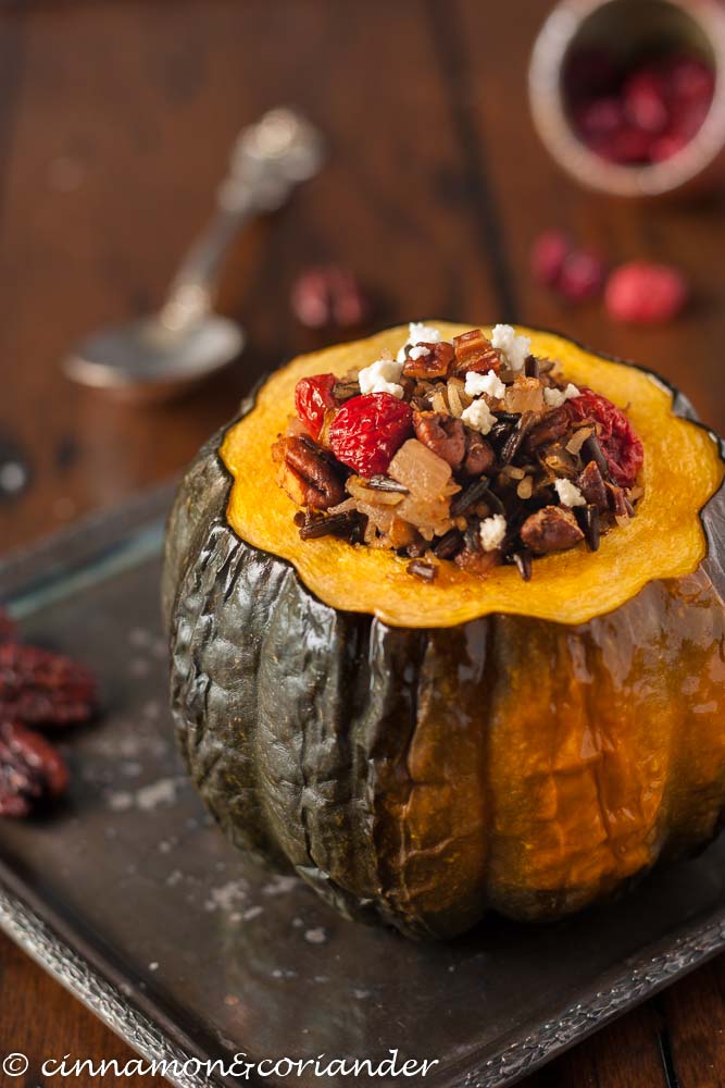 Vegetarian Stuffed Acorn Squash with wild rice, dried cherries, goat cheese and pecans on a silver platter