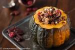 baked stuffed acorn squash filled with wild rice, dries cherries, pecans and goat cheese served on a small silver plate