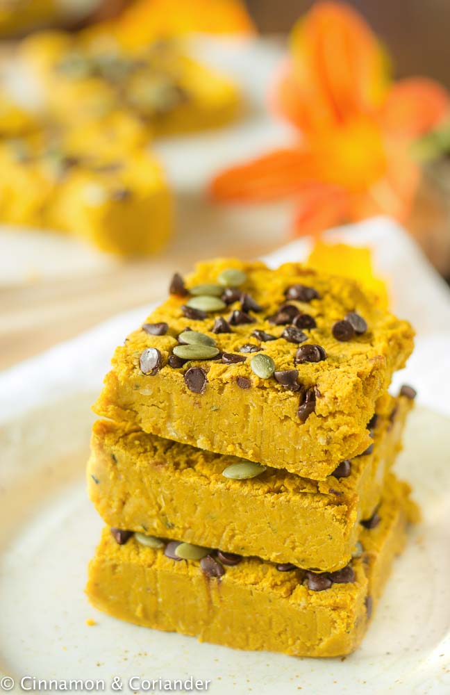 healthy pumpkin bars with sugar-free chocolate chips and pepitas stacked on top of each other